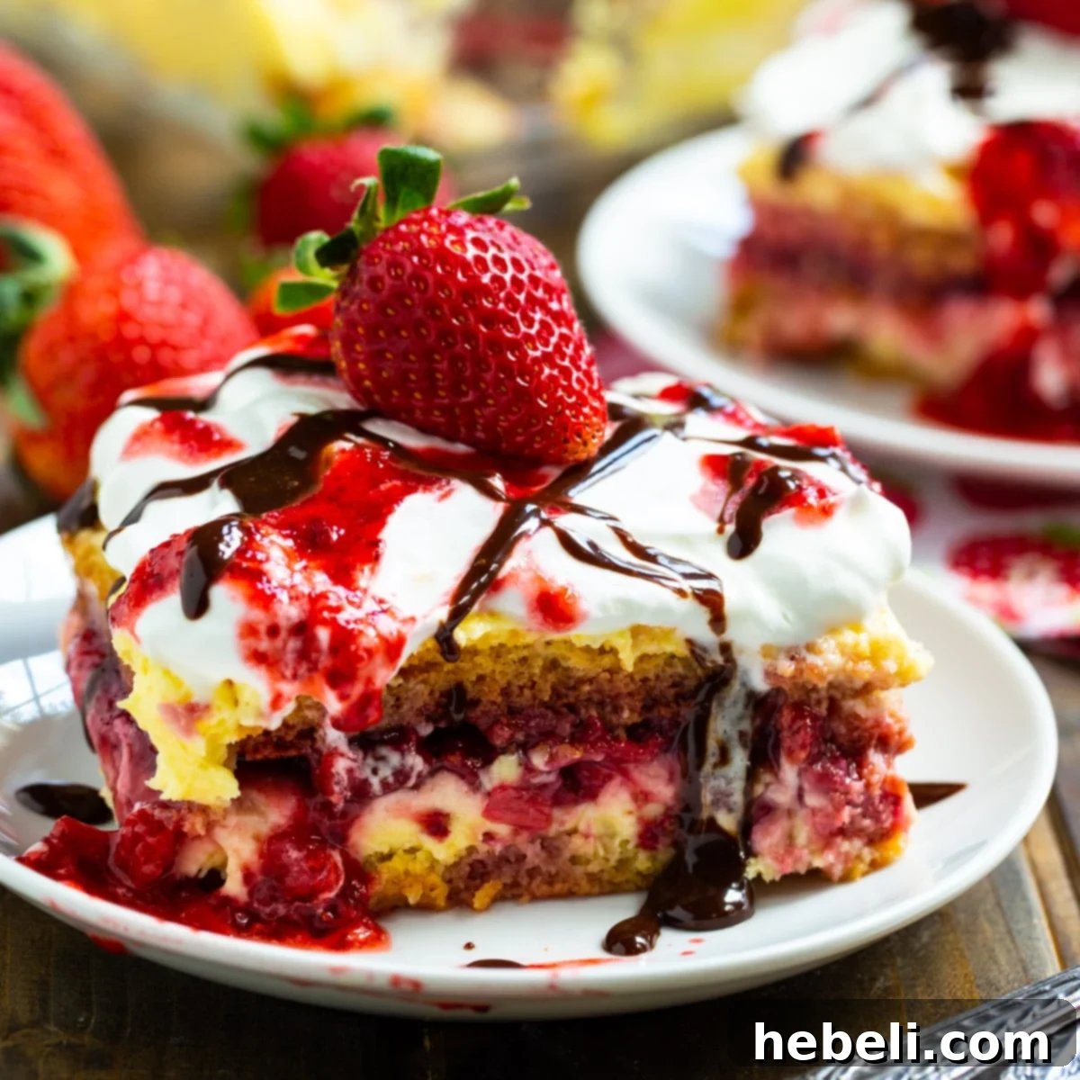 No-Bake Strawberry Lasagna Bliss 2 Slice of No-Bake Strawberry Lasagna on a plate, showing distinct layers of pound cake, cream cheese, and strawberries.