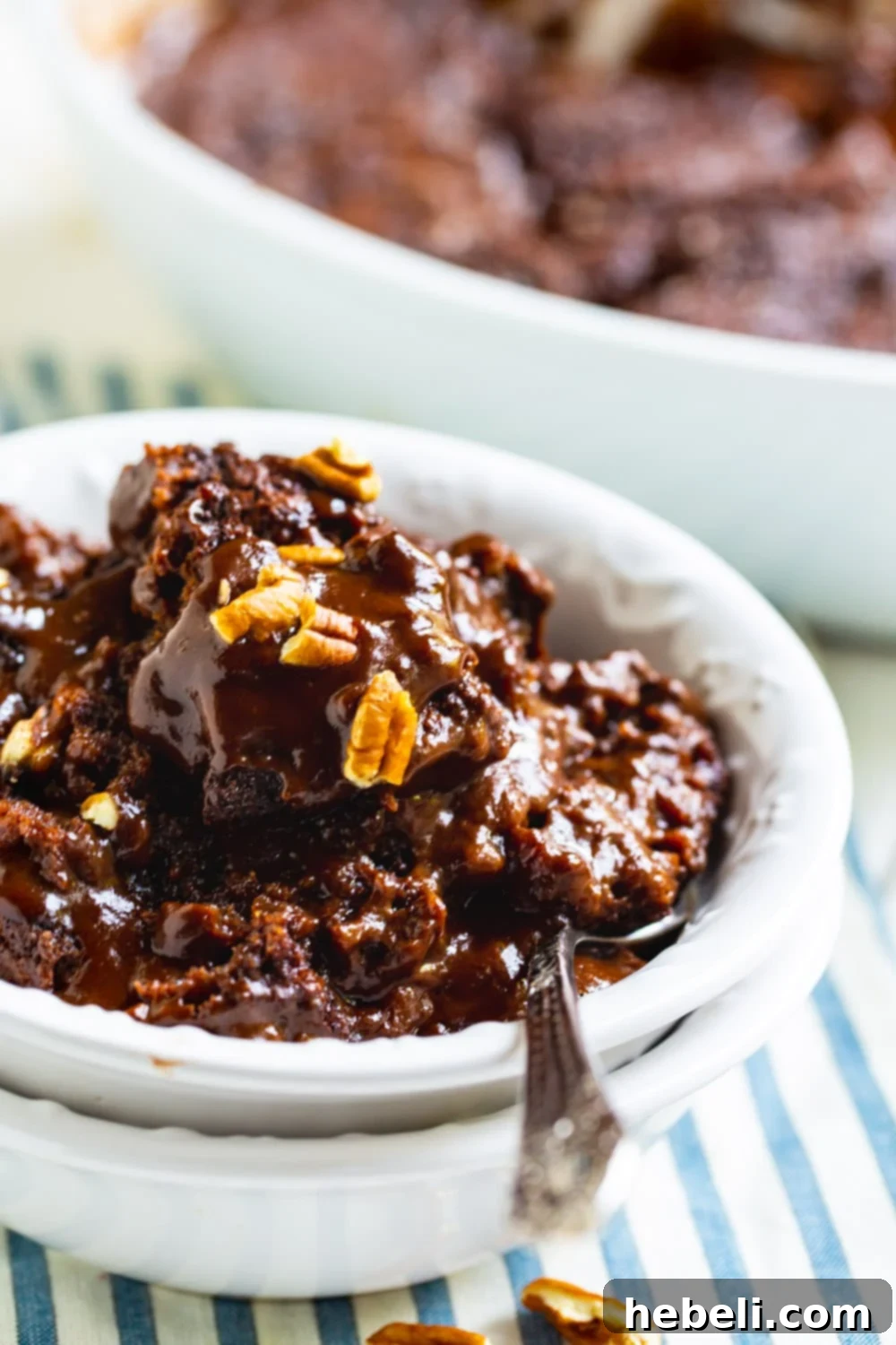Chocolate Cobbler in a bowl with a spoon, highlighting its fudgy interior.