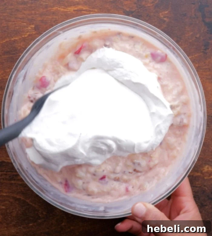 Ultimate No Fuss Millionaire Pie 6 Folding Cool Whip into the fruit and condensed milk mixture for the pie filling.