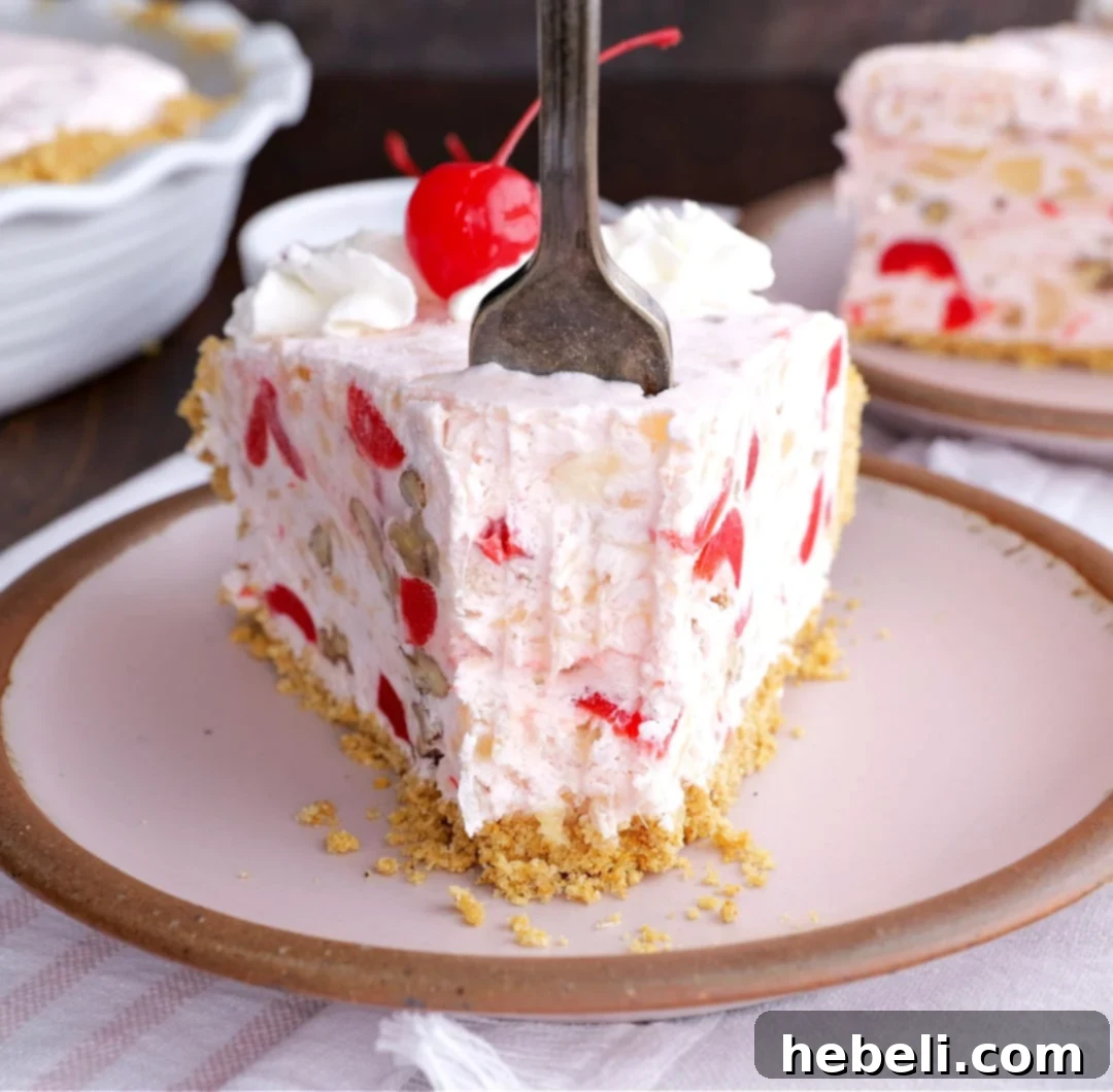 Ultimate No Fuss Millionaire Pie 9 A fork sinking into a creamy slice of Millionaire Pie, revealing its rich texture.