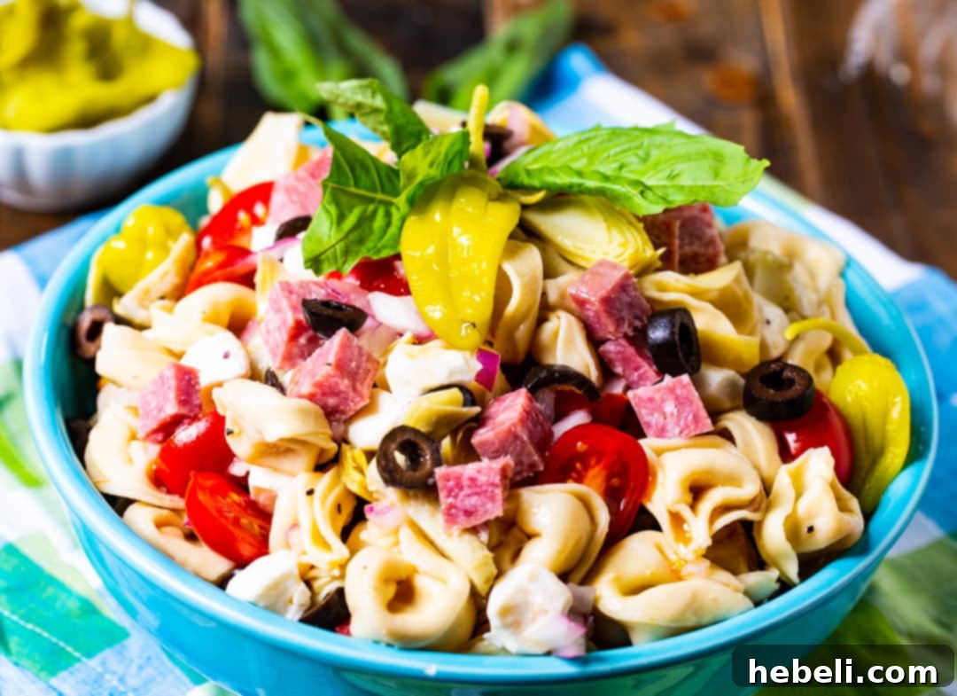 Pasta Salad topped with fresh basil in a rustic blue bowl.