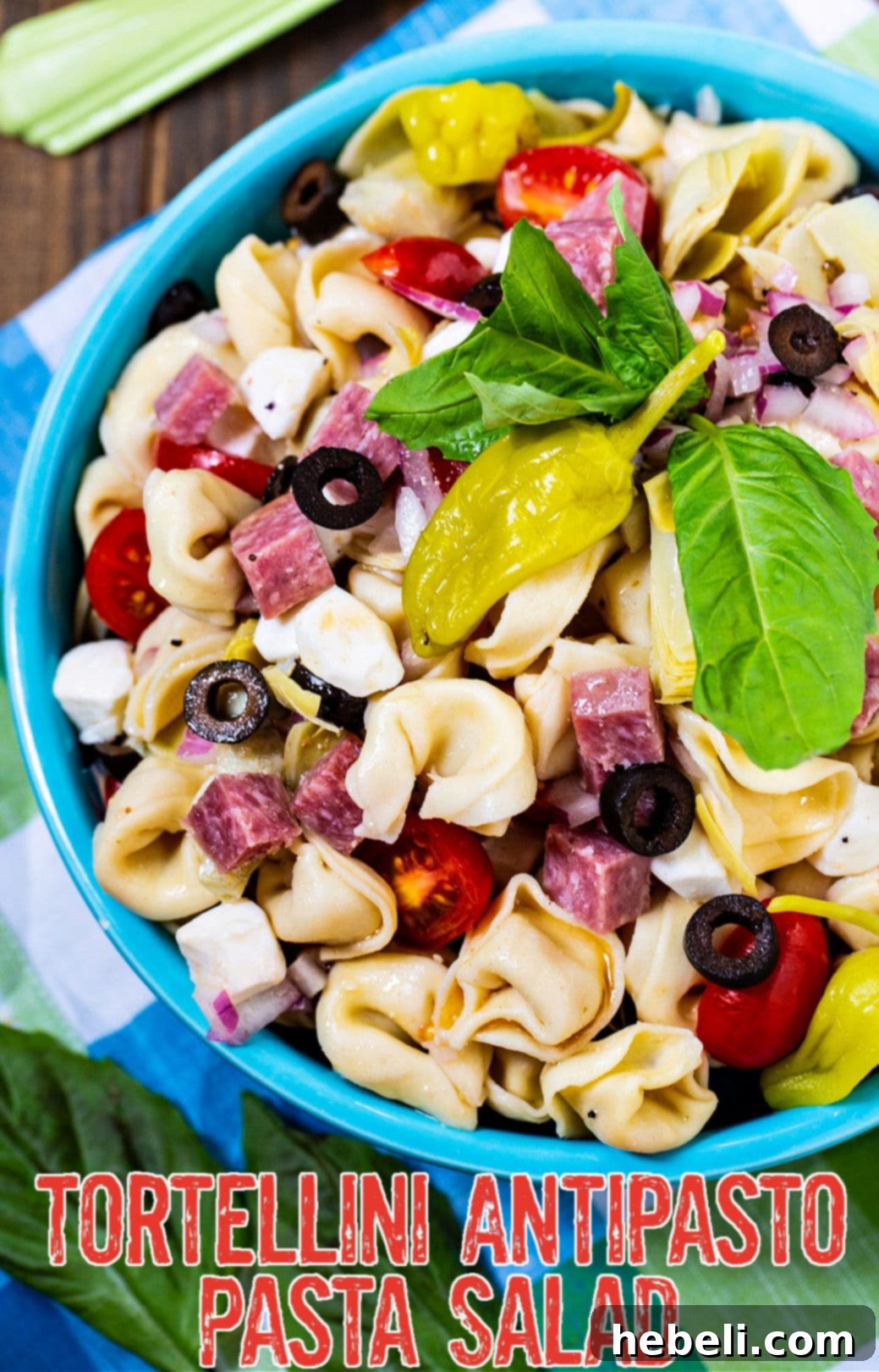 Tortellini Pasta Salad in a blue serving bowl, ready to be served.
