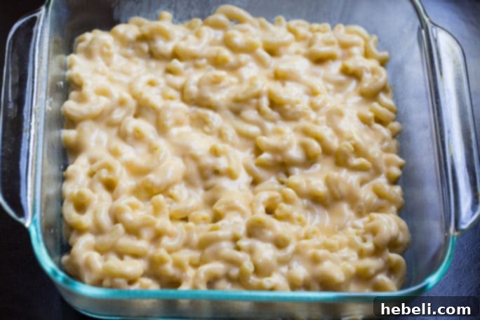 Batch of freshly fried mac and cheese balls piled on a serving plate.
