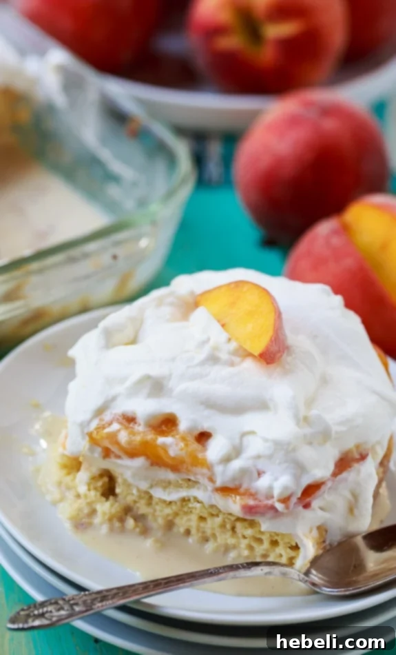 Luscious Peach Bourbon Tres Leches 3 A vibrant, full Peach Bourbon Tres Leches Cake, beautifully topped with fresh peach slices and a cloud of whipped cream, ready to be served.