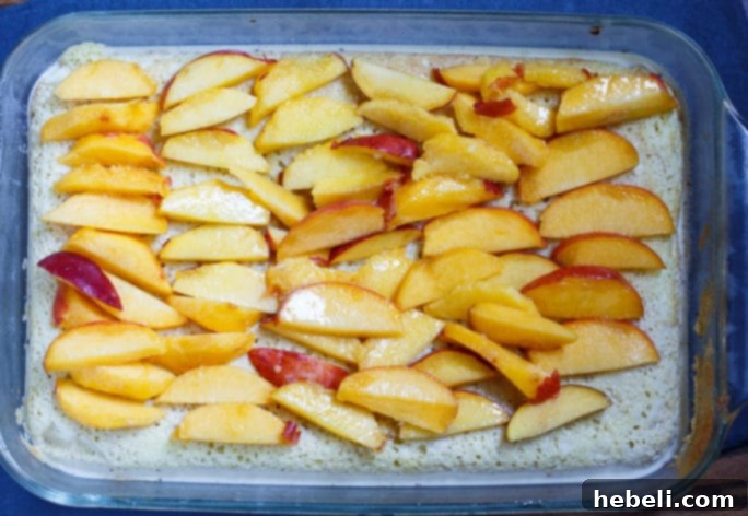 Luscious Peach Bourbon Tres Leches 4 A closer detail shot of the Peach Bourbon Tres Leches Cake, highlighting the juicy peaches and the pristine whipped cream topping.