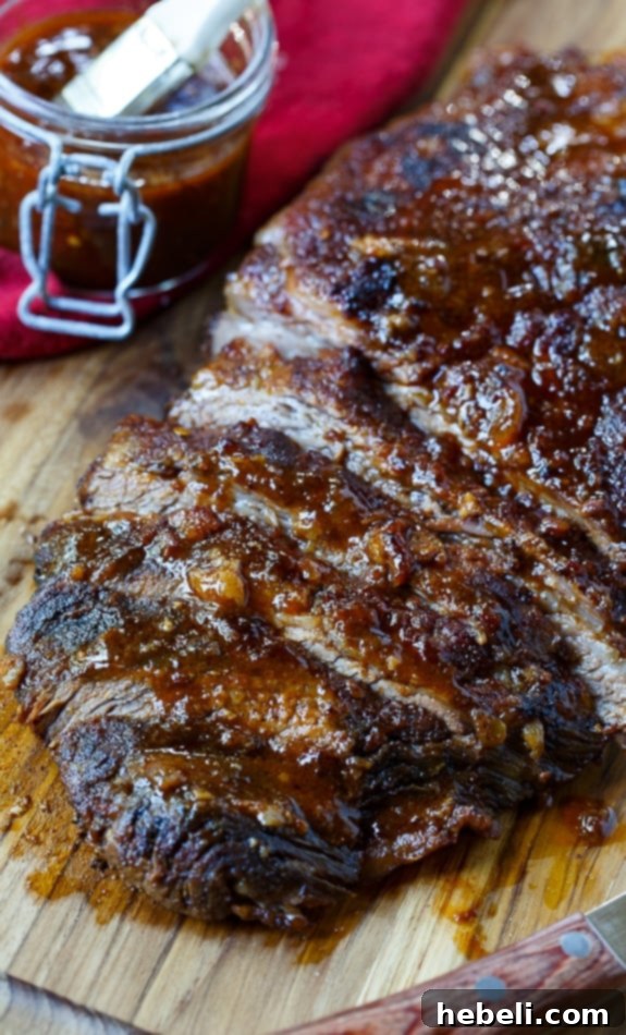 Close-up of tender oven brisket with a perfect char, served on a platter