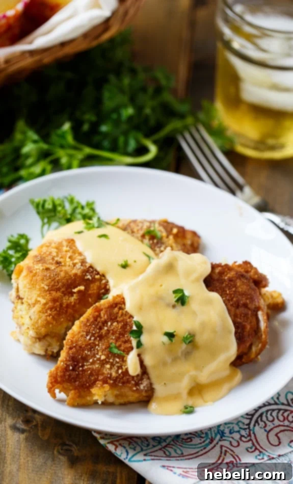 Cheesy Chicken Breasts fresh out of the pan, showcasing the crispy cracker coating.