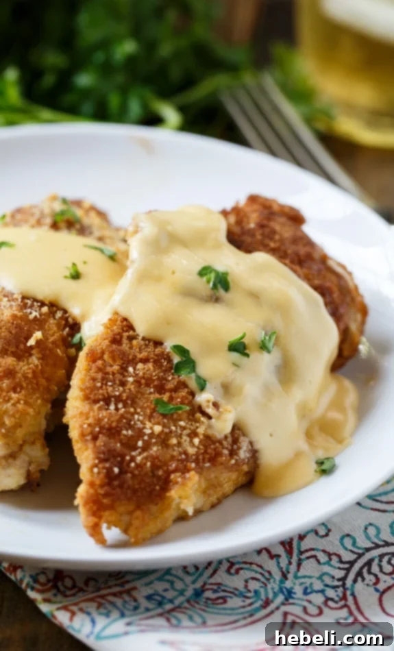 Cheesy Chicken Breasts with a rich cheddar sauce, served with simple sides.