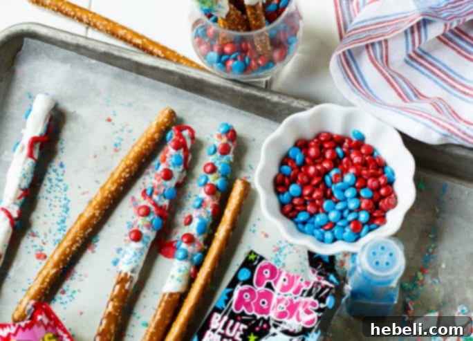 Flavor Burst Pretzel Rods 4 Firecracker Pretzel Rods specifically prepared for the 4th of July, with a close-up on the Pop Rocks candy topping.