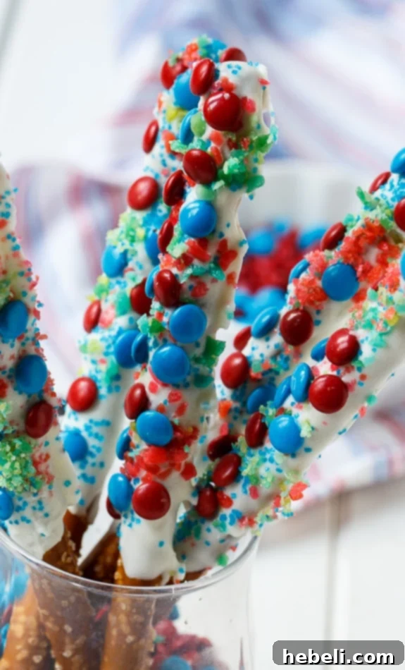 Flavor Burst Pretzel Rods 6 Array of festive Firecracker Pretzel Rods, decorated with red and blue M&Ms and Pop Rocks, celebrating the 4th of July spirit.