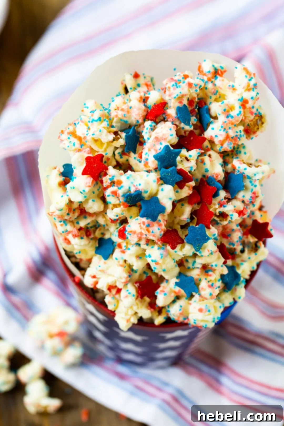 Firecracker Popcorn elegantly presented in a red, white, and blue paper cup, ideal for serving at parties.