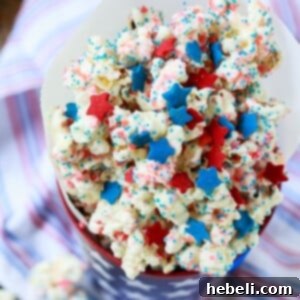 Firecracker Popcorn, a festive 4th of July treat covered in Pop Rocks candy, perfect for parties.