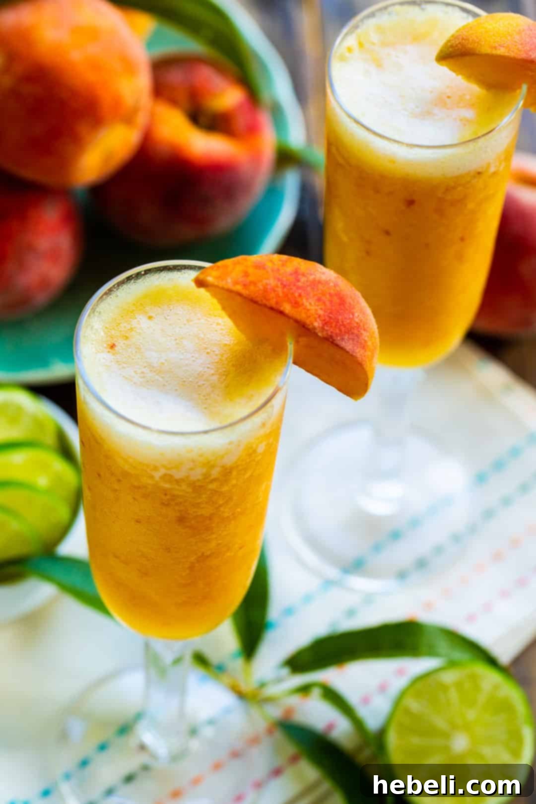 Icy Peach Delight 3 Peach Bellini mocktails served in elegant champagne glasses.