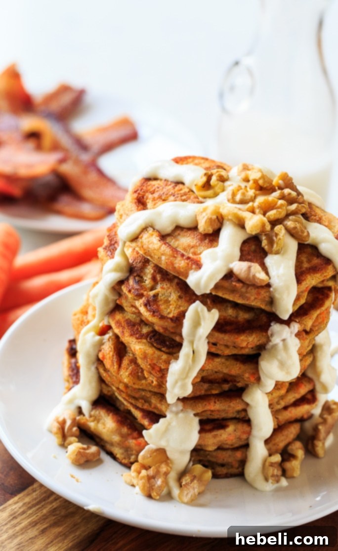 Freshly made Carrot Cake Pancakes stacked high with glaze
