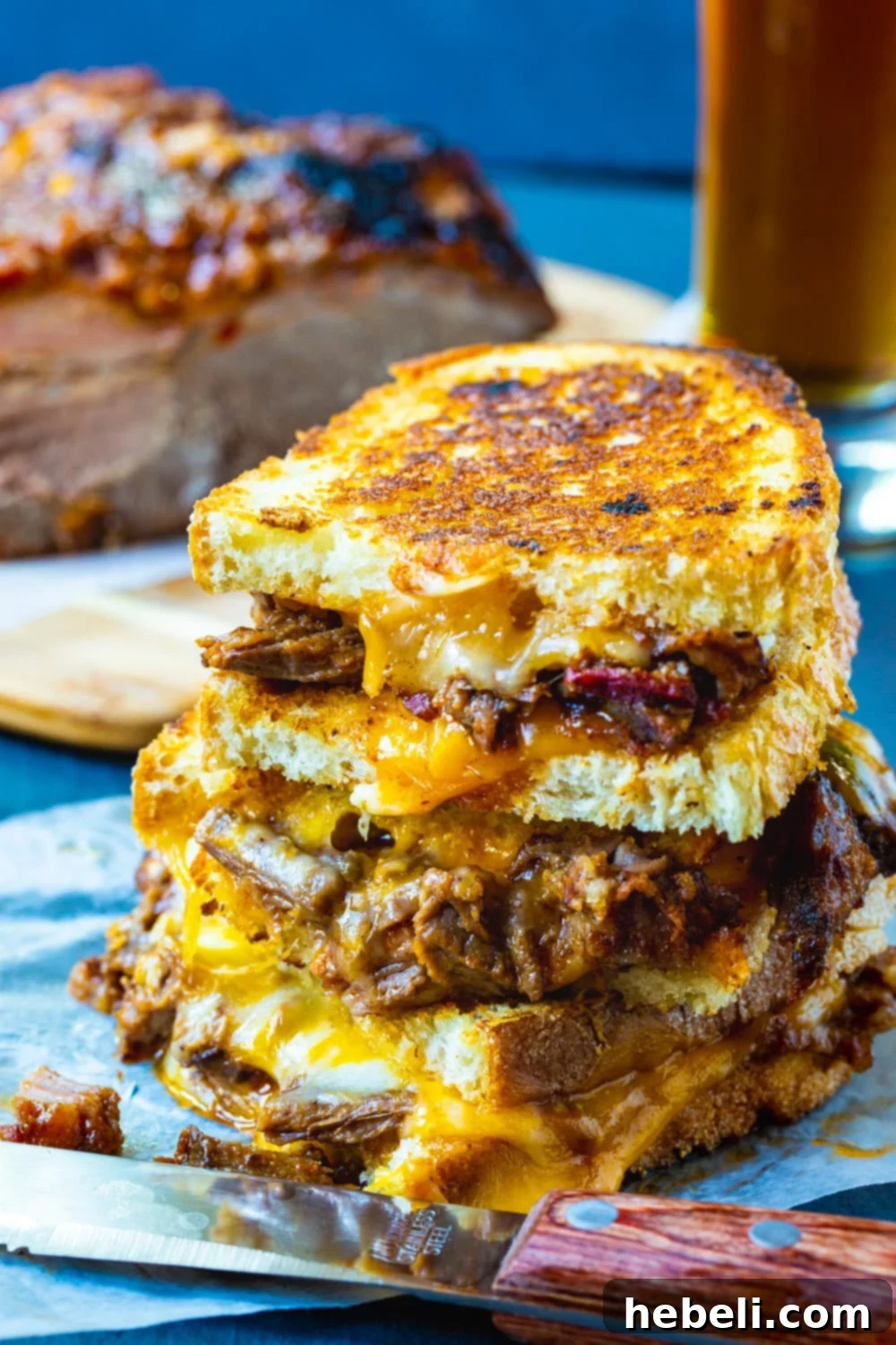 Brisket Grilled Cheese sandwiches stacked on top of each other, highlighting the golden-brown crust and ample filling.