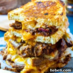 Brisket Grilled Cheese halves stacked on top of each other, ready to be enjoyed.