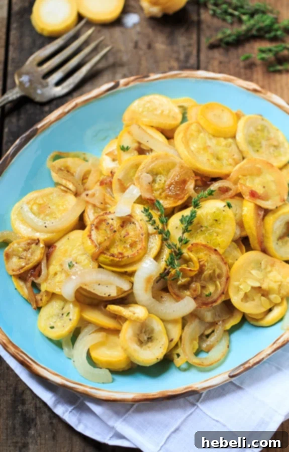 Freshly cooked pan-fried summer squash and onions, ready to be seasoned and served.
