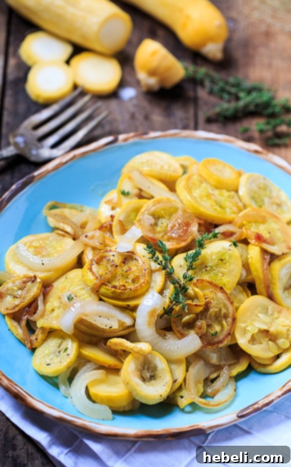 A close-up of a serving of pan-fried summer squash and onions in a bowl, ready to be enjoyed.