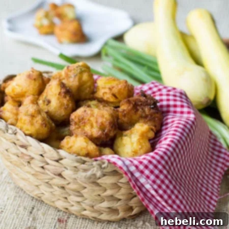 A plate of golden brown, crispy squash hush puppies, a classic Southern side.