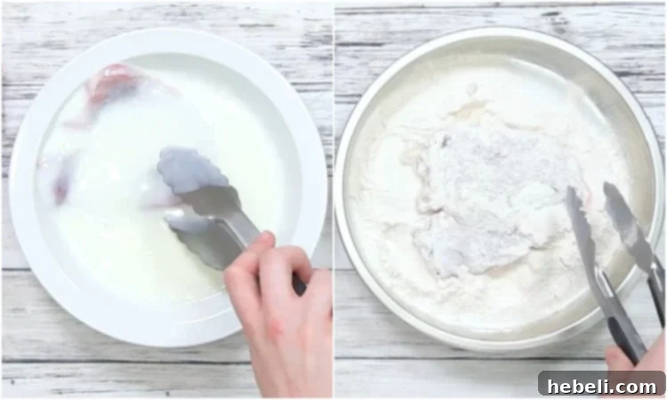 Hands dipping a pork chop first in buttermilk and then coating it in flour, preparing it for frying.