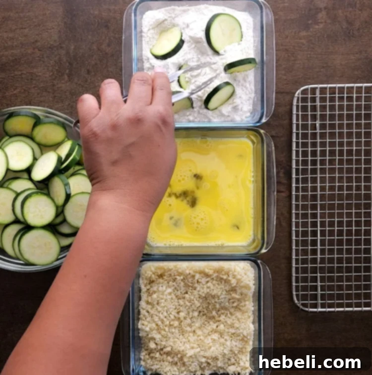 Golden Zucchini Crisps 5 Detailed image of coating zucchini slices in flour, egg, and then Panko breading.
