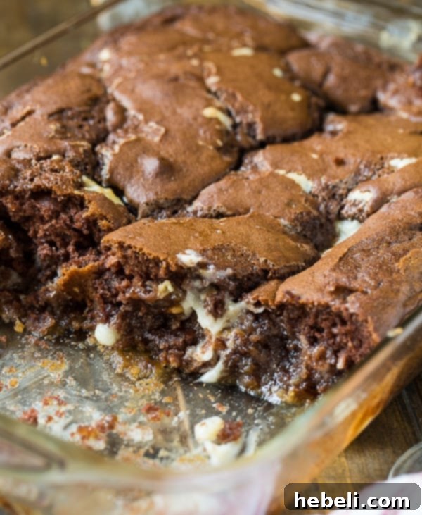 Slice of German Chocolate Upside Down Cake topped with fresh whipped cream