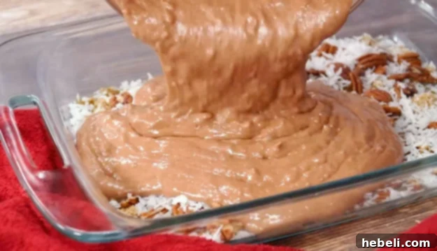 Pouring German Chocolate cake batter into the prepared baking pan
