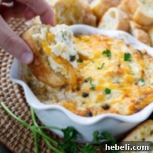 Hot Crab Dip in a white bowl, ready to be served as an appetizer.