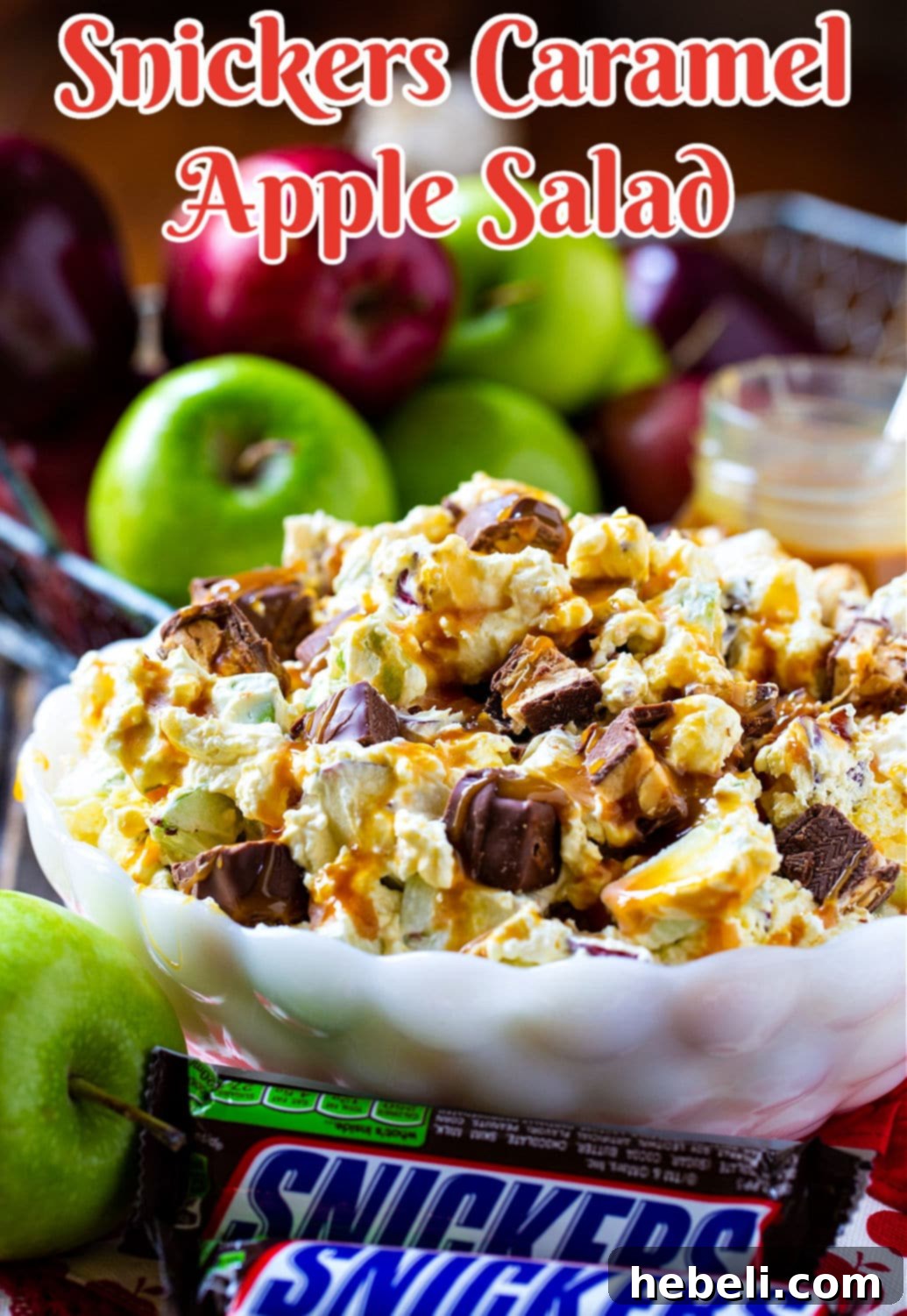 Snickers Caramel Apple Salad in a pristine white serving bowl, showcasing its creamy texture and apple chunks.