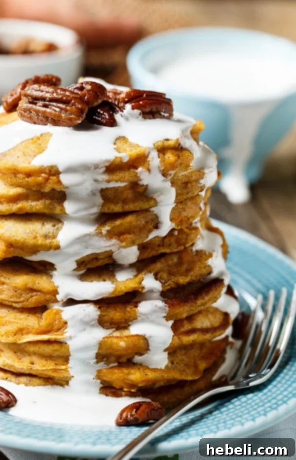 Close-up of golden-orange Sweet Potato Pancakes stacked high, waiting for delicious toppings.