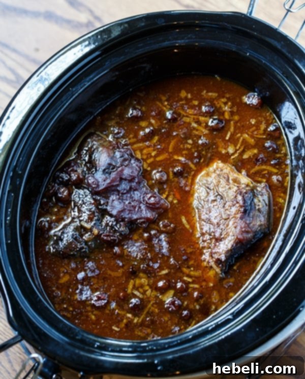 Slow Cooker Pot Roast is super easy and has tons of flavor from dry onion soup mix, tomato sauce, and cranberry sauce.