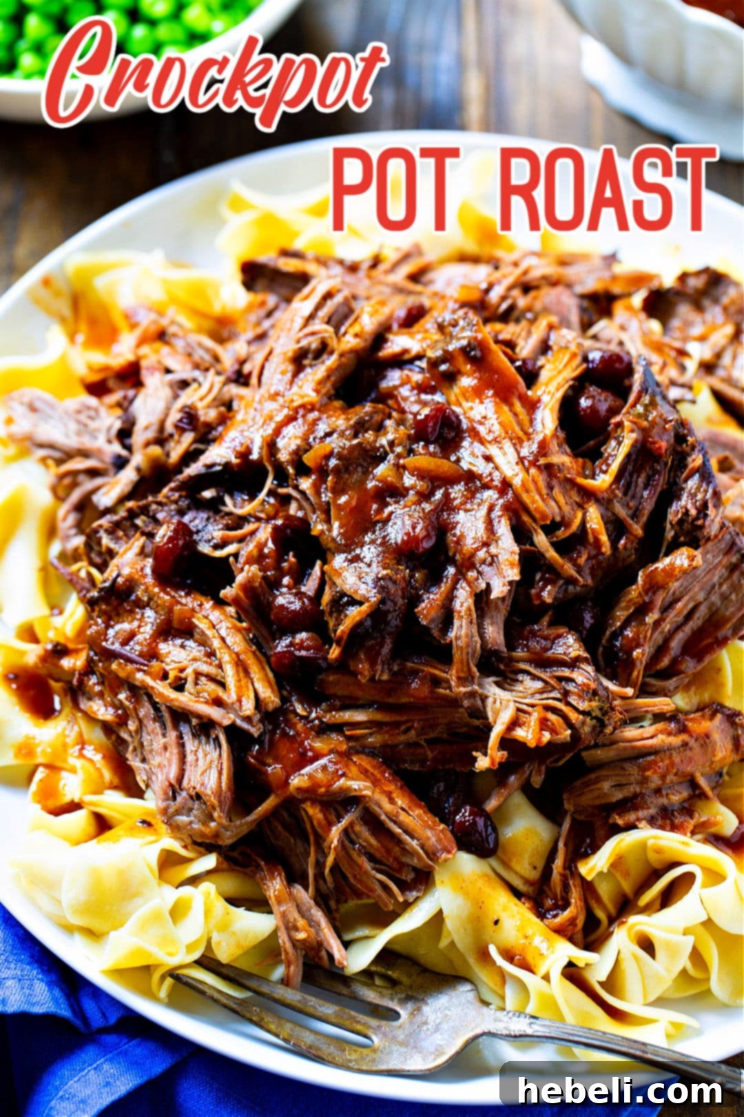 Crock Pot Pot Roast served over buttered noodles.