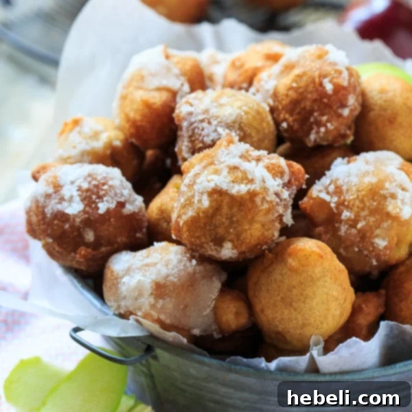 Spiced Apple Delight Puffs 3 Several freshly fried Bourbon-Glazed Apple Fritters with a bottle of Jack Daniel's Tennessee Whiskey, highlighting the key ingredient for the adult treat.