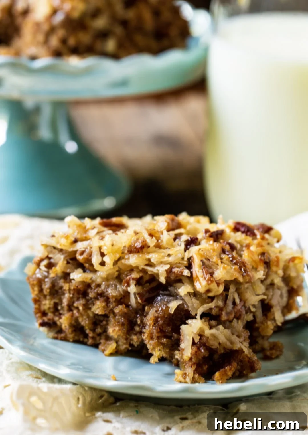 Grandma's Oatmeal Cake 3 A close-up of a slice of Old-Fashioned Oatmeal Cake on a blue ceramic plate, showing its moist texture and rich icing.