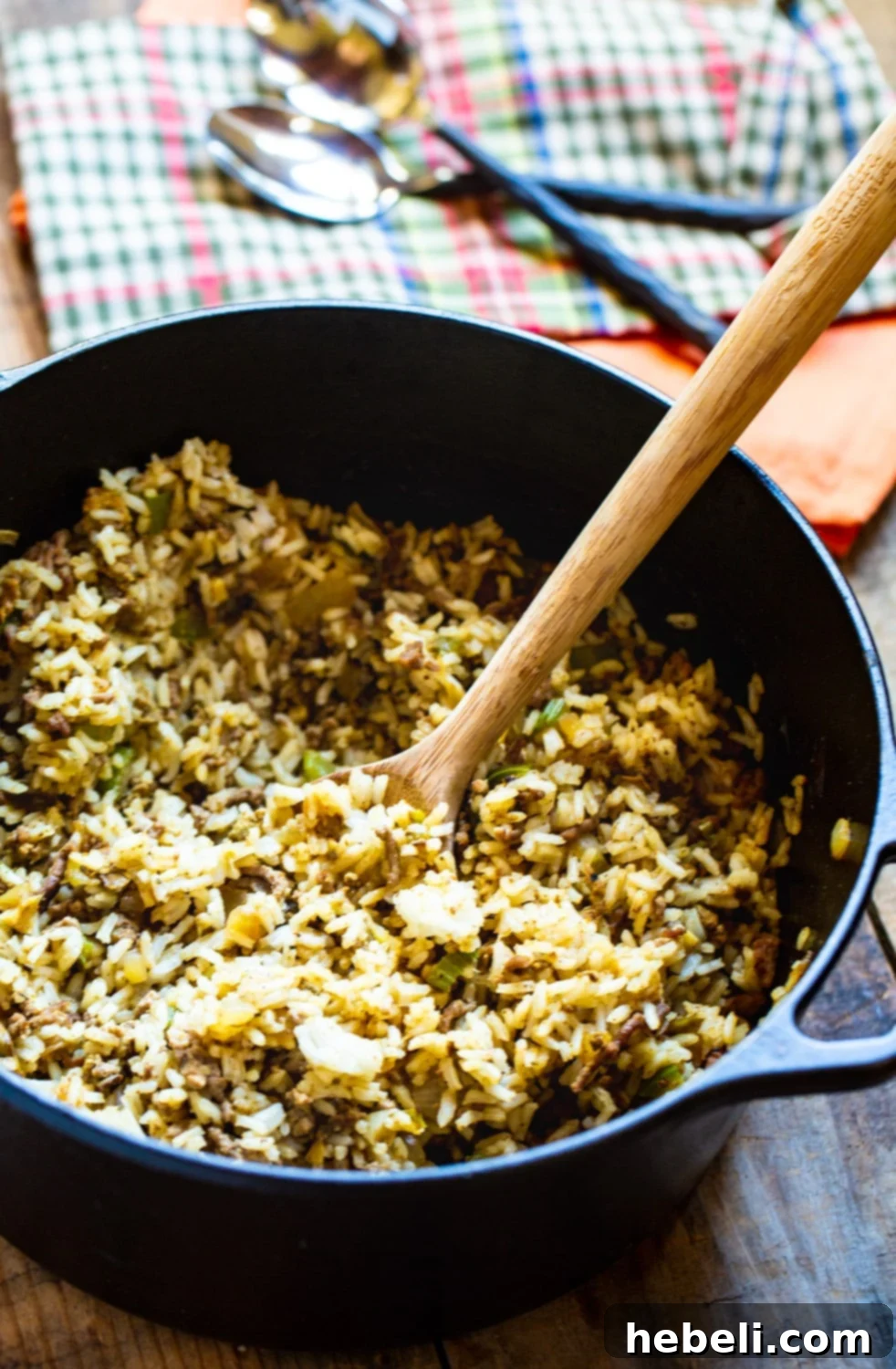 The Holy Trinity ingredients – chopped onion, celery, and green bell pepper – displayed alongside fresh garlic and dried spices, ready for cooking Dirty Rice.