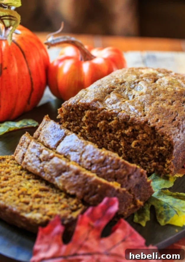 Zesty Pumpkin Loaf 3 A freshly baked loaf of Spicy Pumpkin Bread cooling on a wire rack, ready to be sliced and served.