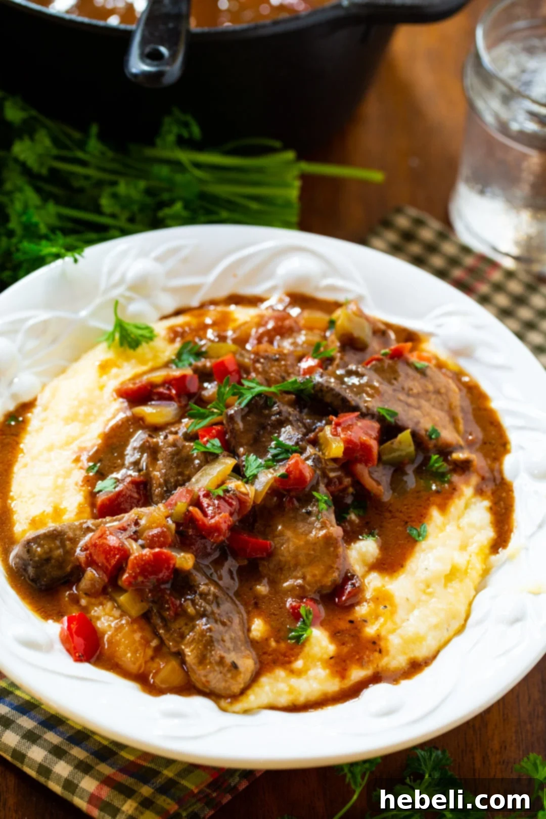 A bowl of Grillades and Grits, showcasing the perfect pairing of rich beef and creamy corn grits.
