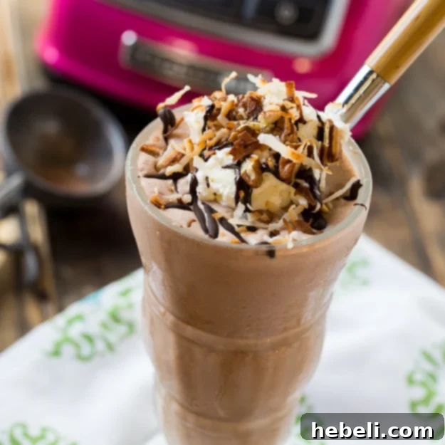 Rich German Chocolate Milkshake topped with coconut, pecans, and chocolate drizzle