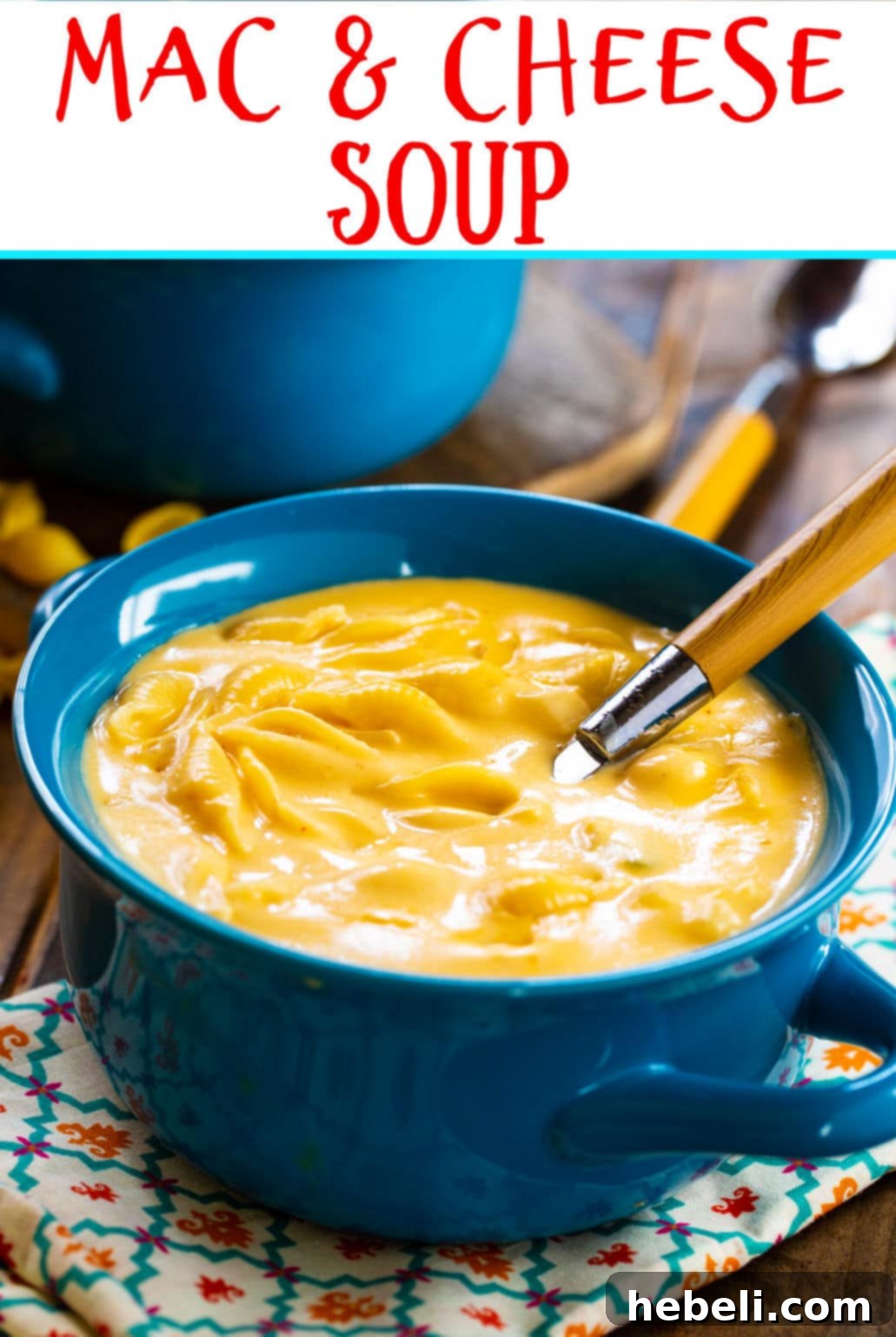 Close-up of Mac and Cheese Soup in a blue bowl, highlighting the abundance of pasta shells and the rich, ultra-cheesy broth.