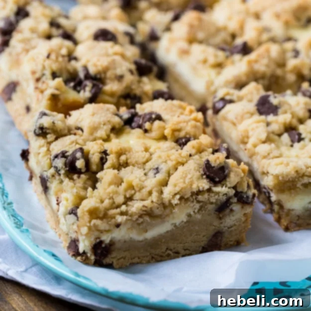 Decadent Chocolate Chip Cheesecake Bars with visible layers of cookie and cheesecake
