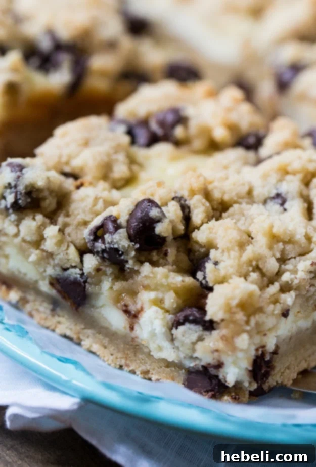 Smooth cheesecake filling spread over the cookie dough base in a baking pan