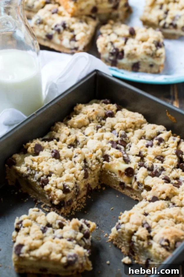 Chocolate Chip Cheesecake Bars served beautifully with a refreshing glass of milk