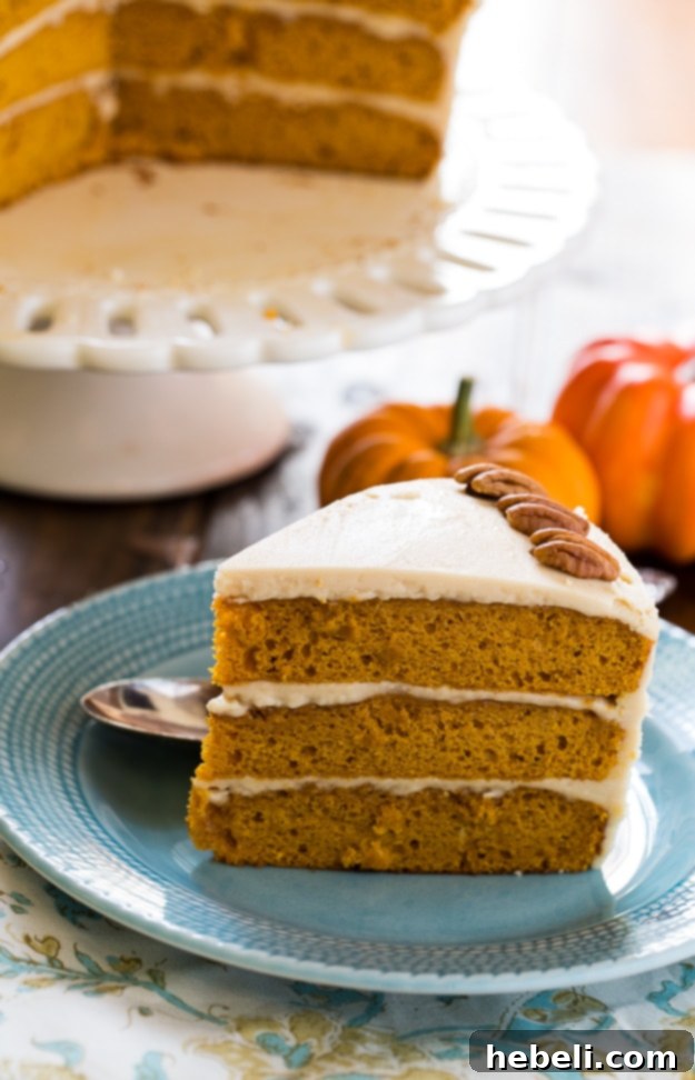 Golden Butterscotch Pumpkin Bliss 4 Elegant three-layer Butterscotch Pumpkin Cake decorated with scattered pecan halves on a pedestal