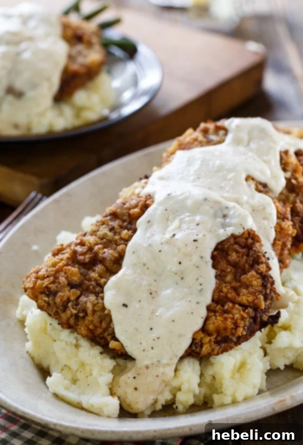 Delicious Chicken Fried Steak with homemade creamy gravy on a plate, ready to serve