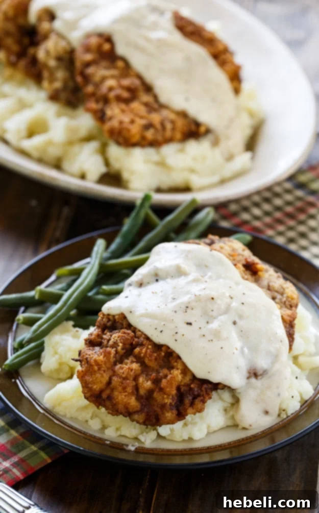 A complete Southern meal with Chicken Fried Steak, mashed potatoes, and green beans served together