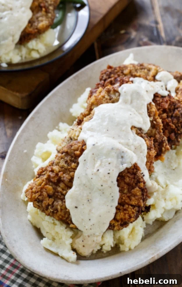 Close-up of golden brown, crispy Chicken Fried Steak with a rich texture