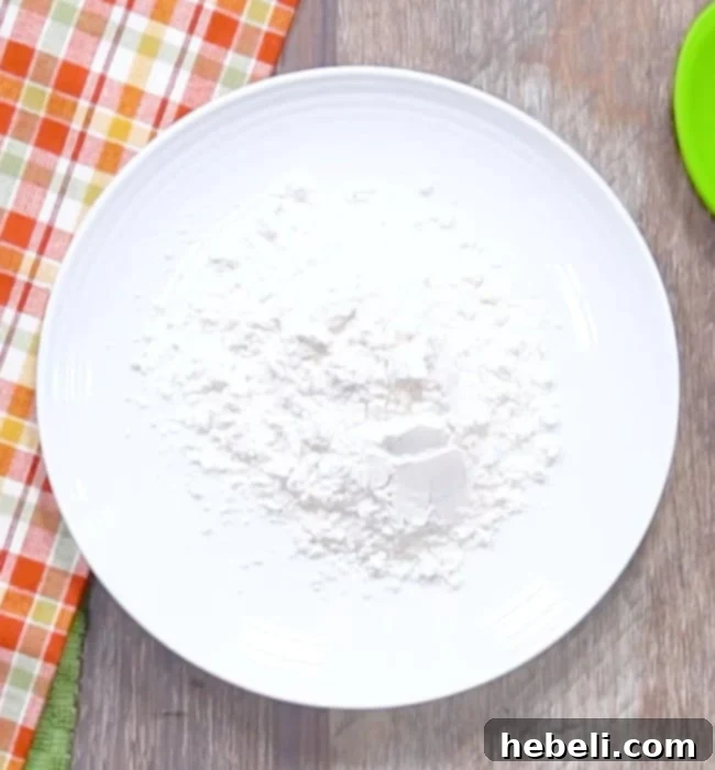 All-purpose flour measured out on a white plate