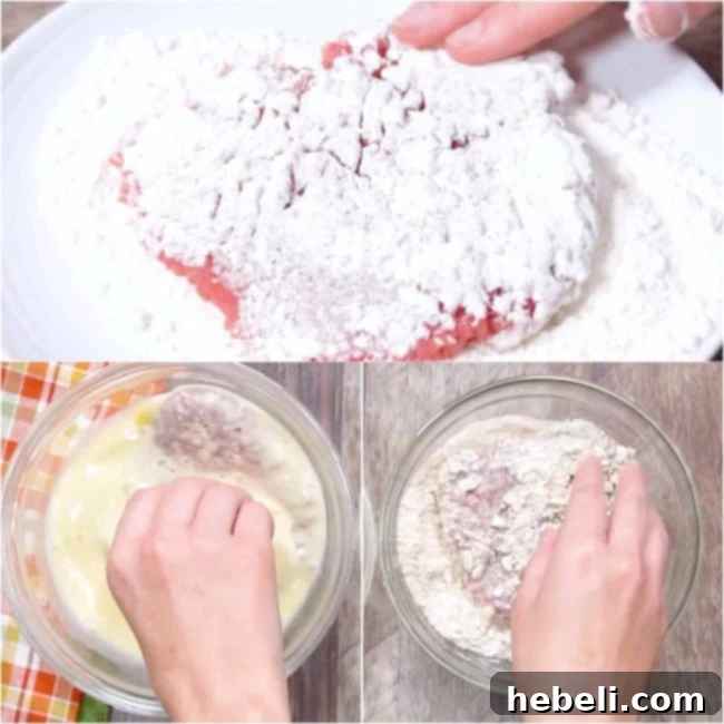 Hand dredging a piece of cubed steak through the cracker and flour mixture