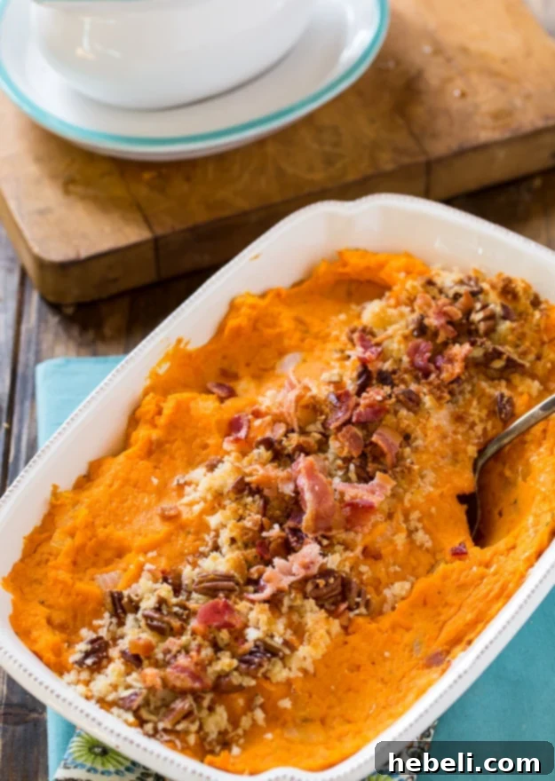 Mixing bowl with mashed sweet potatoes and seasonings for the savory casserole.