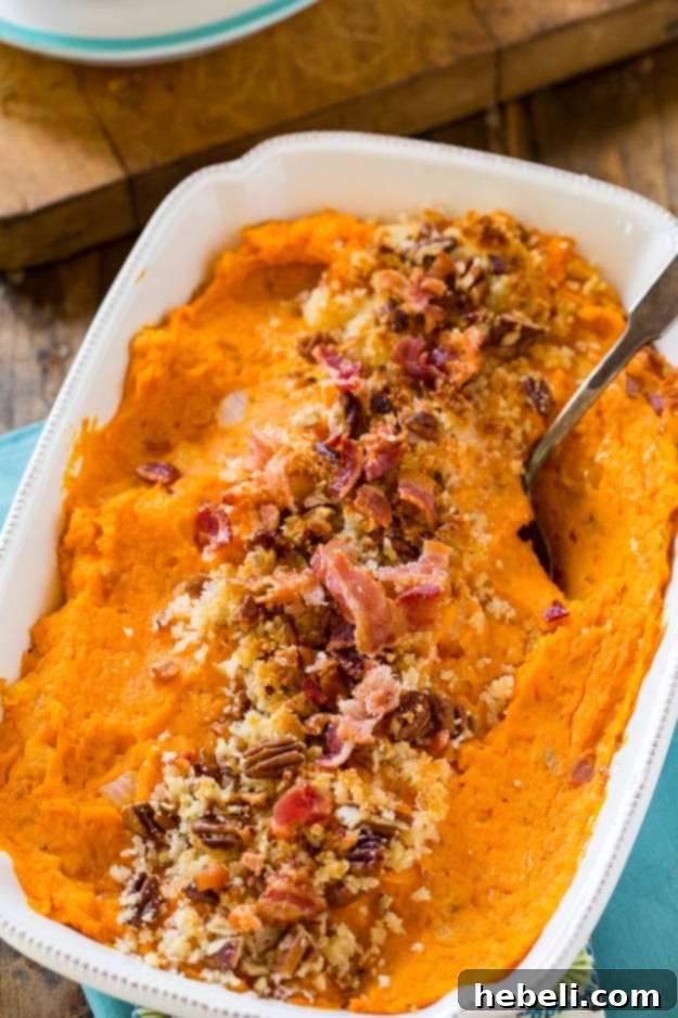 Savory Sweet Potato Casserole topped with Gruyère, Panko, and pecans before baking.